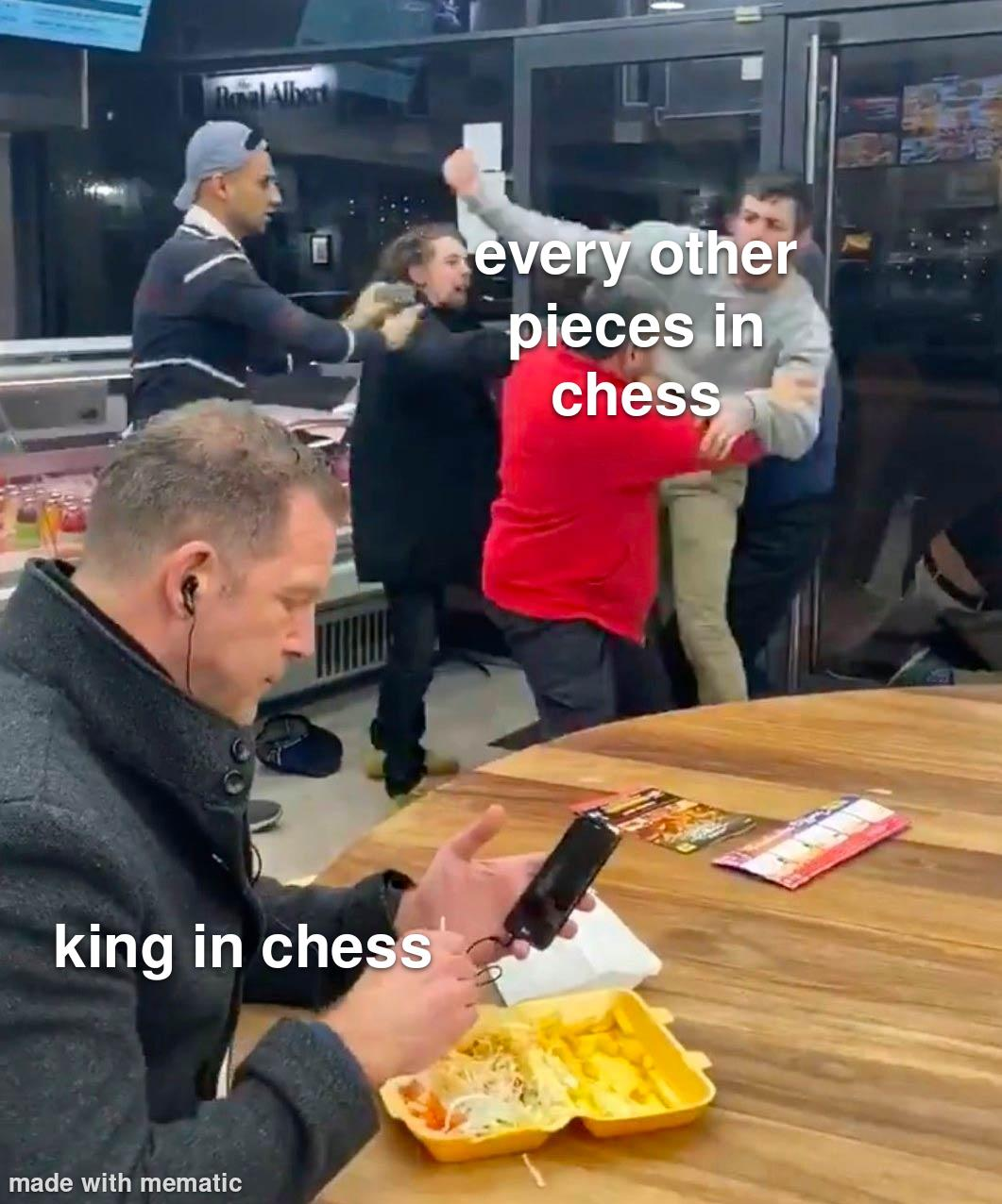 This image humorously depicts the contrasting scenes of a man, entirely unperturbed, listening to something through his earbuds and focused on his phone in what appears to be a café, while utter chaos erupts in the background. The meme is captioned with “Every other piece in chess” placed over the chaotic fight scene in the background, and “The King in chess” placed over the unfazed man in the foreground.
