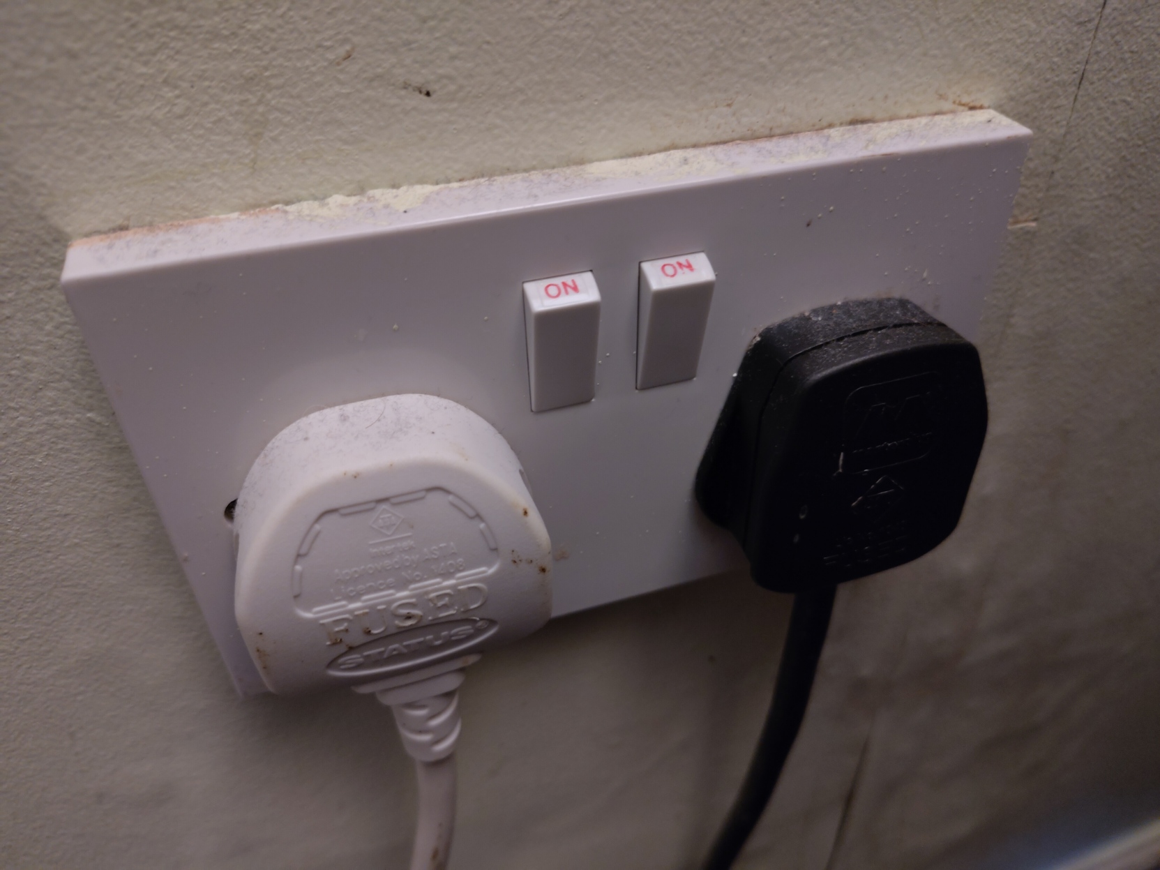 uk plug socket with plugs in