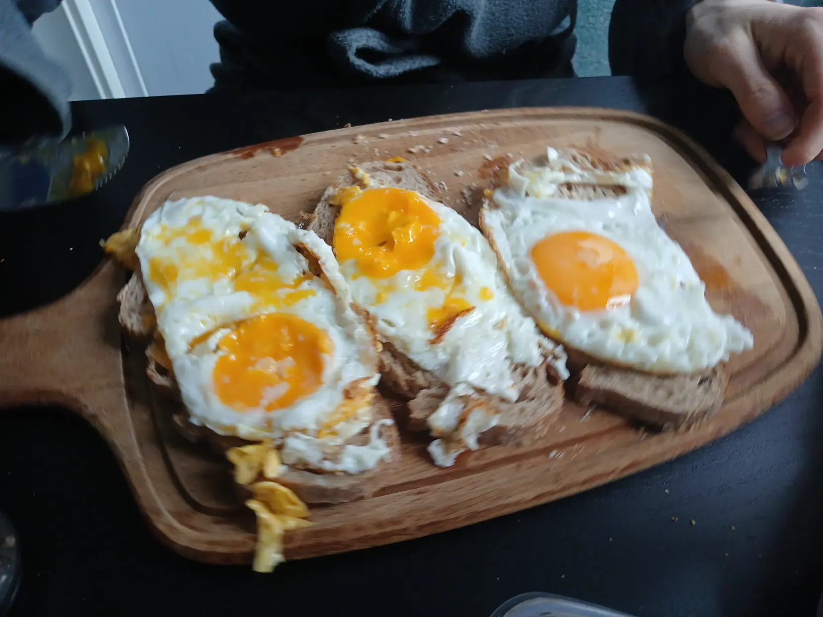 Picture of three cooked eggs on bread