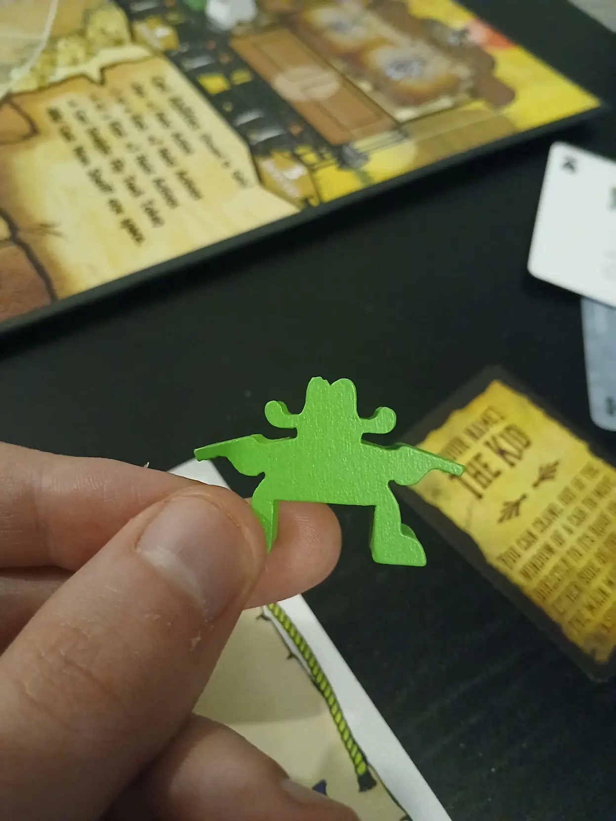 A very wide cowboy meeple (wooden boardgame figure)