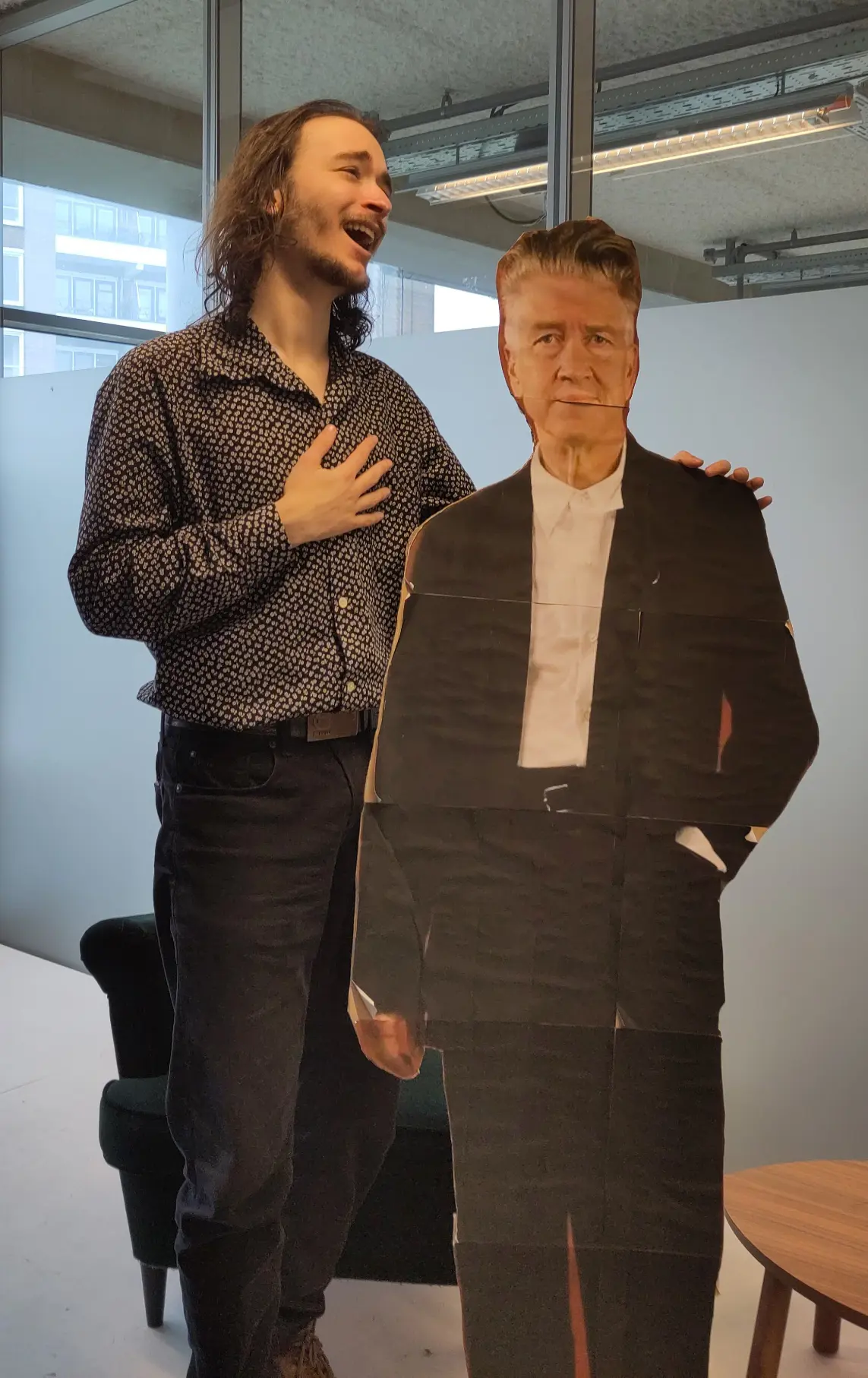 A picture of Hertog with a 1,5 meter tall cardboard cutout of David Lynch