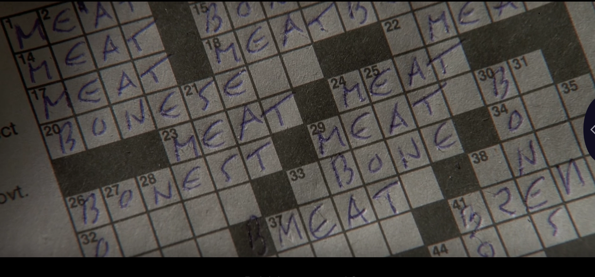 screenshot of American Psycho that shows a crossword being fillled in with mostly "meat" and "bone" 