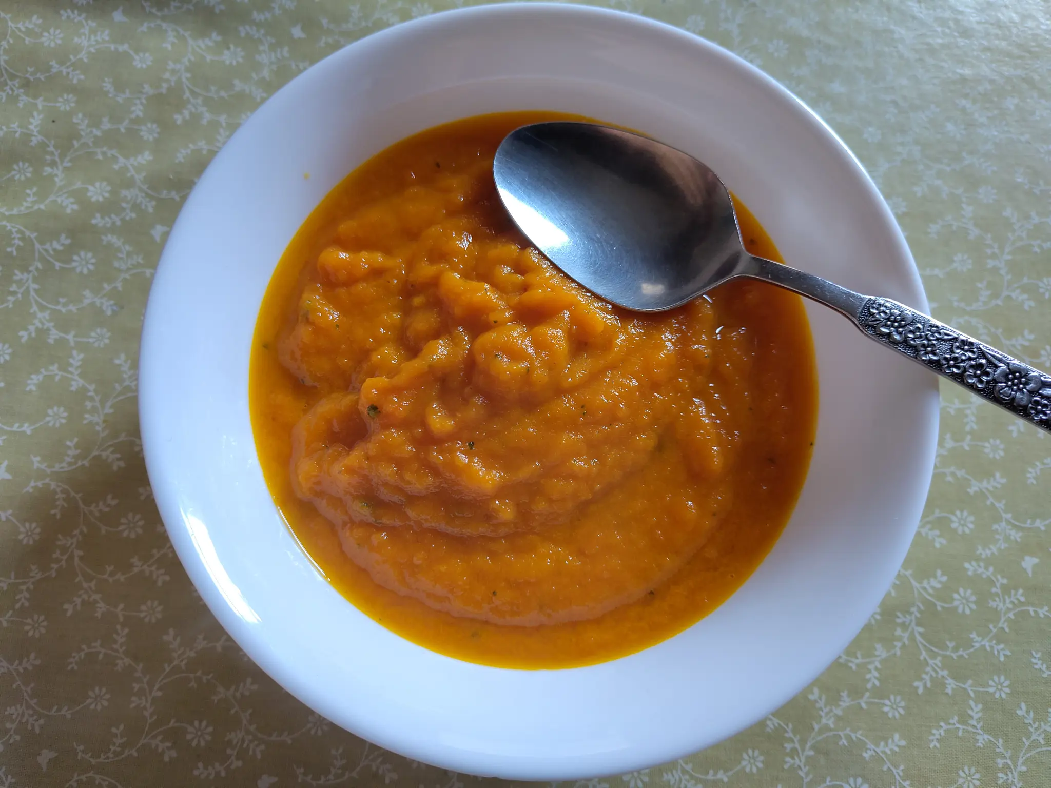 a bowl of fresh carrot and coriander soup
