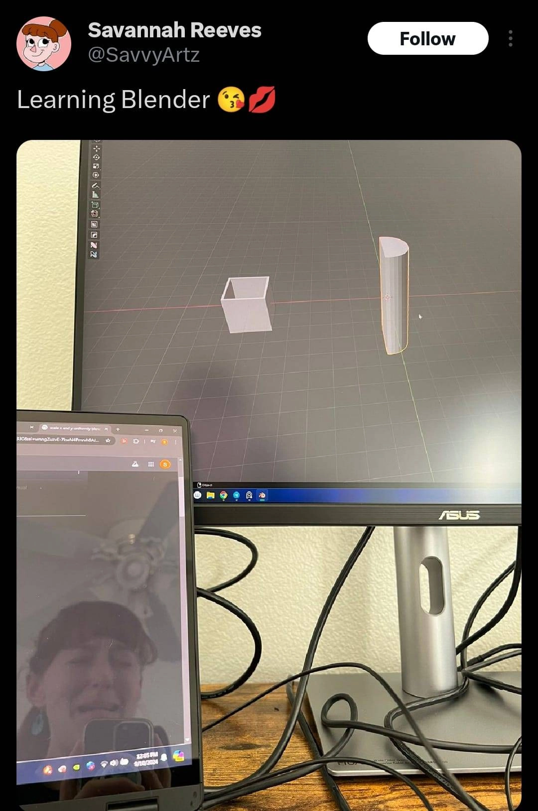 tweet by user @SavvyArtz captioned "Learning Blender :kissyemoji: :lipemoji:" followed by a picture of someone's desktop with blender open with some shapes. In the left corner is a laptop in which you can see a reflection of the user crying