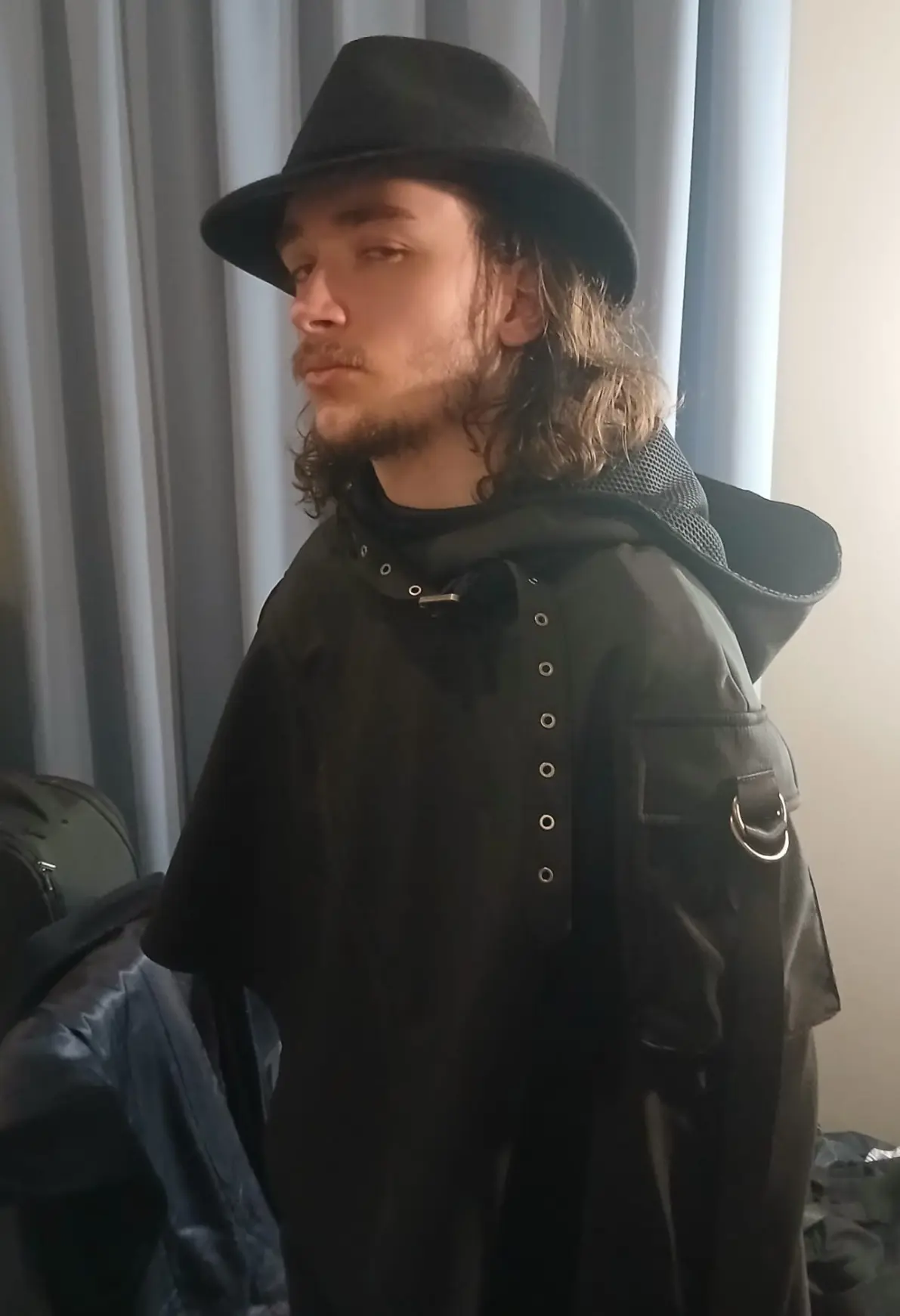 Me wearing a black fedora and a black cloat with some cool belts (trust)

Apologies for ass alt text